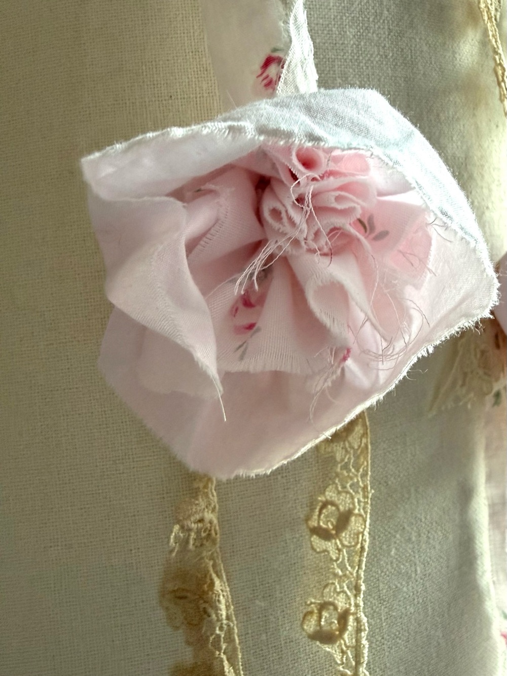 pink fabric rose necklace on top with vintage lace at bottom